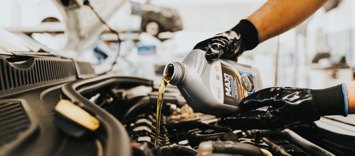 Replacing vehicle oil. Photo by Daniel Andraski, Pexels.